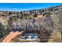 Stately home with a brick facade, a large yard and picturesque mountain views at 19 Red Fox Ln, Littleton, CO 80127