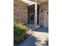 Side view of covered porch with stone and landscaping at 13349 Krameria St, Thornton, CO 80602