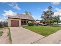 Single-story home showcasing a well-kept front yard, attached garage, and long driveway at 3270 W 92Nd Pl, Westminster, CO 80031