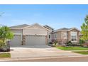 Beautiful home with stone accents, three-car garage, and well-maintained lawn in a desirable neighborhood at 8691 S Sicily Ct, Aurora, CO 80016
