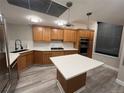 Well-equipped kitchen featuring an island, wooden cabinets, modern appliances, and bright countertops at 1350 Lawrence St # 2F, Denver, CO 80204