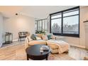 Inviting living room with a comfortable couch, large windows, and a stylish coffee table at 1350 Lawrence St # 2F, Denver, CO 80204
