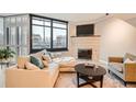 Cozy living room with large windows, a fireplace, and ample seating at 1350 Lawrence St # 2F, Denver, CO 80204