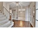 Elegant foyer with tile flooring, chandelier, staircase, and views to multiple rooms at 7058 S Madison Way, Centennial, CO 80122