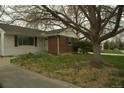 Beautiful home featuring a well-maintained lawn and brick and vinyl siding at 3091 S Holly Pl, Denver, CO 80222