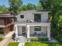 Beautiful two-story home with a covered front porch, second-story balcony, and a well-maintained front yard at 332 S Franklin St, Denver, CO 80209