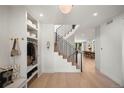 Bright foyer with a staircase, coat closet, and view into the dining and living areas at 332 S Franklin St, Denver, CO 80209