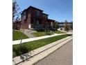 Attractive two-story home featuring a covered front porch and well-maintained landscaping at 17822 E 107Th Pl, Commerce City, CO 80022