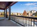 Relaxing porch view with a sturdy railing, overlooking a peaceful neighborhood on a bright, sunny day at 17822 E 107Th Pl, Commerce City, CO 80022