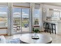 Open living space with access to deck through sliding glass doors and adjacent kitchen at 2996 Savage Rd, Elizabeth, CO 80107