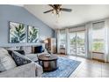 Cozy living room with vaulted ceilings, large windows, and access to the deck at 2996 Savage Rd, Elizabeth, CO 80107