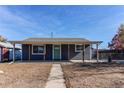 Newly renovated gray house with green door and covered porch at 7780 Hollywood St, Commerce City, CO 80022