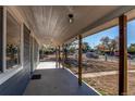 Covered front porch with wooden posts and concrete flooring at 7780 Hollywood St, Commerce City, CO 80022