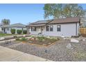 Charming single-story home featuring a well-maintained yard, solar panels and a cozy front entrance at 1655 S Lowell Blvd, Denver, CO 80219