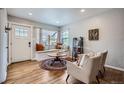 Cozy living room featuring a window seat, hardwood floors, and ample natural light at 1655 S Lowell Blvd, Denver, CO 80219