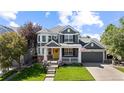 Beautiful two-story home featuring a landscaped front yard, inviting porch, and attached two-car garage at 16376 Stonefeld Pl, Parker, CO 80134