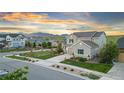 Beautiful two-story home with a lush lawn, landscaping, and mountain views set in a Gathering-friendly neighborhood at 17335 W 94Th Ave, Arvada, CO 80007
