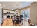 Eat-in kitchen featuring stainless steel appliances, hardwood floors and sliding glass doors at 9680 Burberry Way, Highlands Ranch, CO 80129