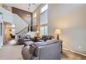 Spacious living room features vaulted ceilings, a staircase and many windows for natural light at 9680 Burberry Way, Highlands Ranch, CO 80129
