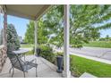 Inviting front porch with comfortable seating and views of the well-maintained lawn at 942 Wagon Bend Rd, Berthoud, CO 80513