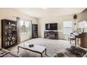 Cozy living room with plush carpet, fireplace, and large windows for natural light at 942 Wagon Bend Rd, Berthoud, CO 80513