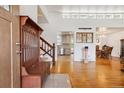 Inviting foyer features hardwood floors, coat rack, and staircase to the second floor at 5856 Simms St, Arvada, CO 80004