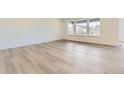 Bright living room with light wood flooring and large windows for ample natural light at 24715 E Evans Dr, Aurora, CO 80018