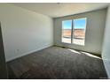 A carpeted bedroom filled with natural light from its double windows at 25343 E Warren Pl, Aurora, CO 80018