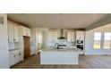 Modern kitchen boasts a center island, stainless steel appliances, and white cabinetry at 25343 E Warren Pl, Aurora, CO 80018