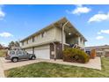 Multi-unit building with attached garages and well-maintained landscaping at 9868 Appletree Pl, Thornton, CO 80260
