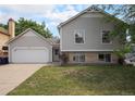 Inviting two-story home featuring a two-car garage and a well-manicured lawn at 12632 James Ct, Broomfield, CO 80020