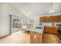 Charming kitchen with wood cabinets and a breakfast nook with a view of the deck at 12632 James Ct, Broomfield, CO 80020