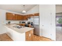 Bright kitchen with stainless steel appliances, breakfast bar, and wood cabinets at 12632 James Ct, Broomfield, CO 80020