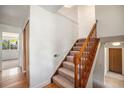 A carpeted staircase with wood railing that leads to the upper level of the home at 12632 James Ct, Broomfield, CO 80020