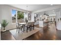 Sun-filled dining room featuring modern lighting, a dining table, and hardwood floors at 5101 Quitman St, Denver, CO 80212