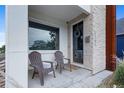 Inviting front porch with seating and stylish entry door featuring a decorative wreath at 5101 Quitman St, Denver, CO 80212
