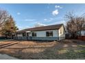 Attractive one-story home featuring a well-maintained lawn and mature trees at 795 Troy Ct, Aurora, CO 80011