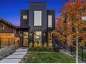 Modern home with dark exterior, striking architecture, and manicured front yard at 3709 Tejon St, Denver, CO 80211