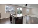 Kitchen with granite countertops, a stainless steel dishwasher, and a view of the living area at 9250 Rifle St, Commerce City, CO 80022
