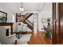 Open-concept living room features beautiful hardwood floors, staircase, fireplace, and bright natural light at 758 N Franklin St, Denver, CO 80218