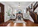 Bright living room featuring a fireplace, hardwood floors, staircase, and many windows at 758 N Franklin St, Denver, CO 80218