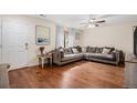 Bright living room with hardwood floors, a large comfortable sofa, and natural light at 10700 Kimblewyck Cir # 225, Northglenn, CO 80233