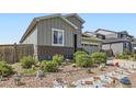 Charming home with grey siding, brick accents, and landscaping at 6924 E 118Th Pl, Thornton, CO 80233