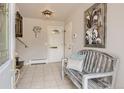 Inviting home entryway featuring neutral tones, tiled flooring, and a wooden bench at 6069 S Marshall Dr, Littleton, CO 80123