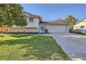 Charming home with a well-kept lawn, inviting front porch, and an attached garage at 6069 S Marshall Dr, Littleton, CO 80123