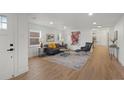 Bright living room with hardwood floors, a neutral color palette, and stylish modern furniture at 3025 Ivanhoe St, Denver, CO 80207