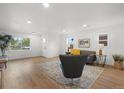 Inviting living room featuring hardwood floors, comfortable seating, and natural light at 3025 Ivanhoe St, Denver, CO 80207