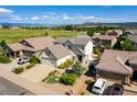 Aerial view of a suburban community with a home featuring lush landscaping and mountain views at 3841 Colorful Ln, Castle Rock, CO 80109