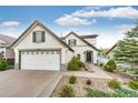 Charming two-story home featuring a well-manicured lawn, mature landscaping and a two car garage at 3841 Colorful Ln, Castle Rock, CO 80109