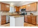 Modern kitchen featuring granite countertops, stainless steel appliances, and custom wood cabinetry at 10825 Mount Antero Way, Parker, CO 80138